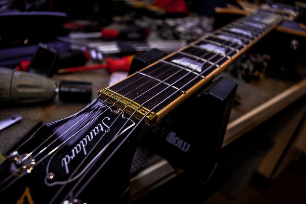 A picture of a guitar setup being performed